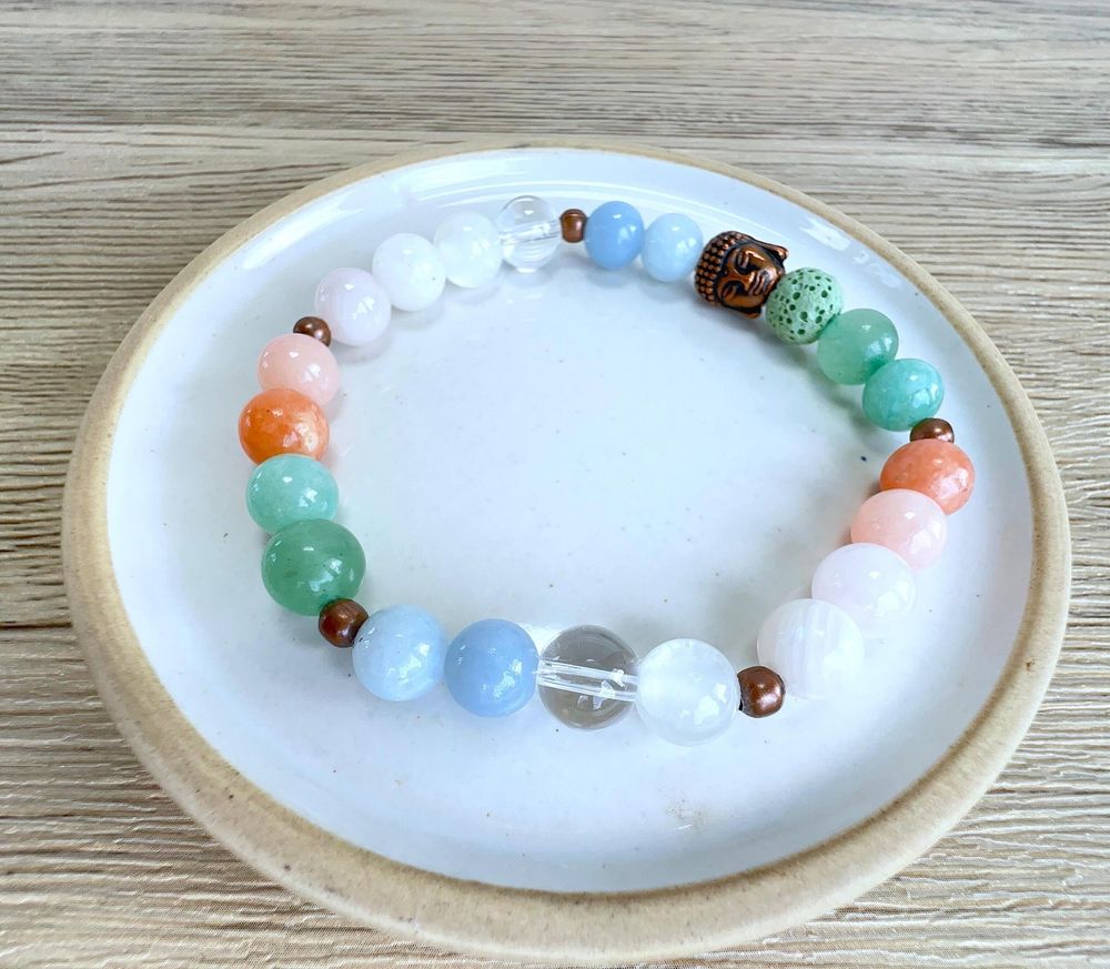 Summer vibes handmade bracelet in whites, peaches, greens and blue with copper buddha head and lava bead