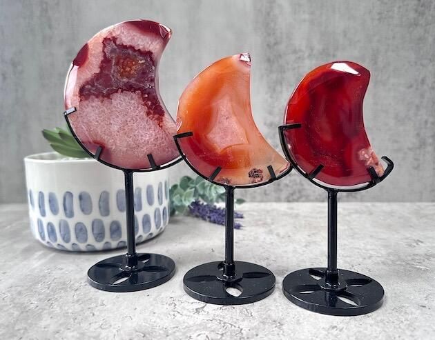 three carnelian moons on black mental stands