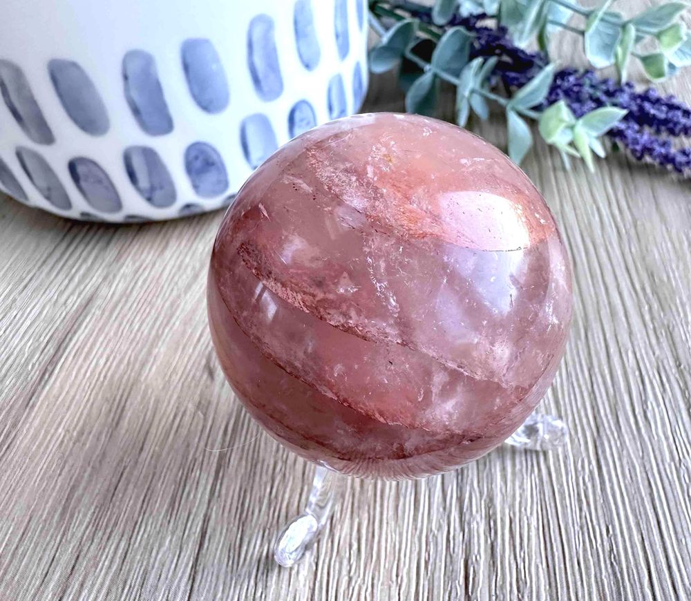 Fire quartz crystal sphere on stand