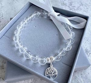 Clear quartz crystal charm bracelet with sterling silver tree of life charm in branded box