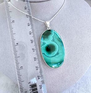 large green oval malachite sterling silver pendant with ruler to show sizing