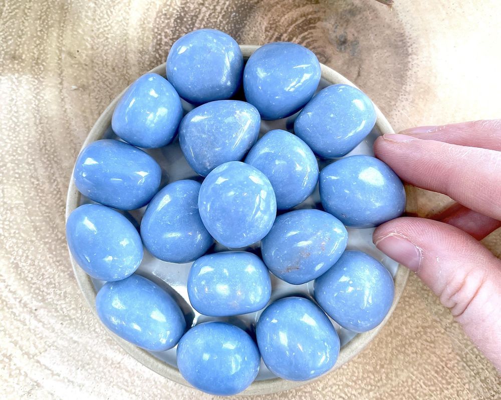 blue Angellite crystal tumbled stones on a plate