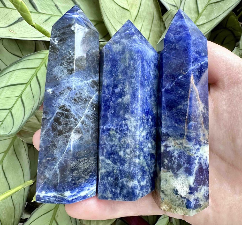 six Sodalite crystal towers blue with white and orange graining