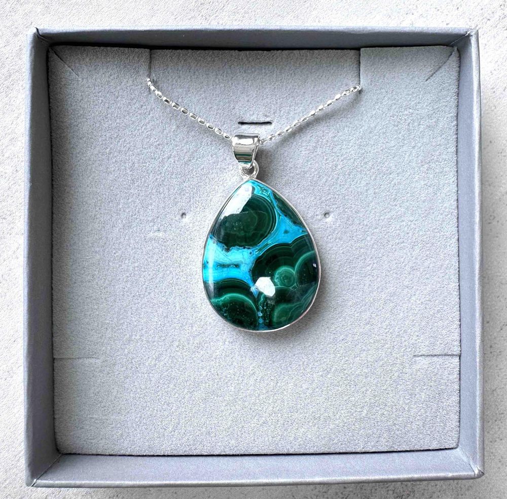 teardrop shape mallacolla sterling silver pendant on a chain in a presentation box