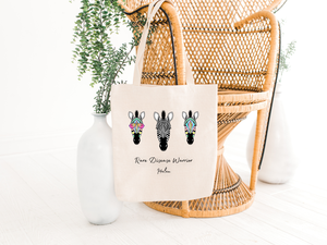 rare disease warrior tote bag hanging on a chair with zebras, the holistic hamper