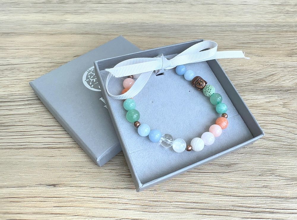 Summer vibes handmade bracelet in whites, peaches, greens and blue with copper buddha head and lava bead
