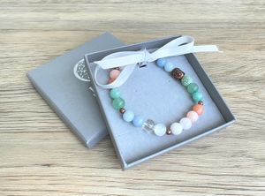 Summer vibes handmade bracelet in whites, peaches, greens and blue with copper buddha head and lava bead