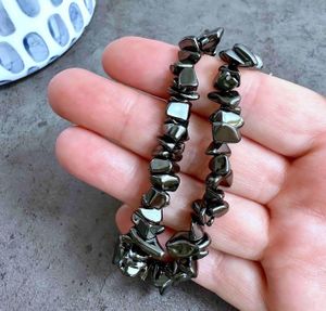 grey metallic hematite chip bracelets one size fits all on a hand