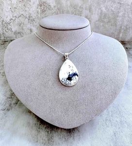 merlinite crystal pendant with optional sterling silver 18inch chain on display