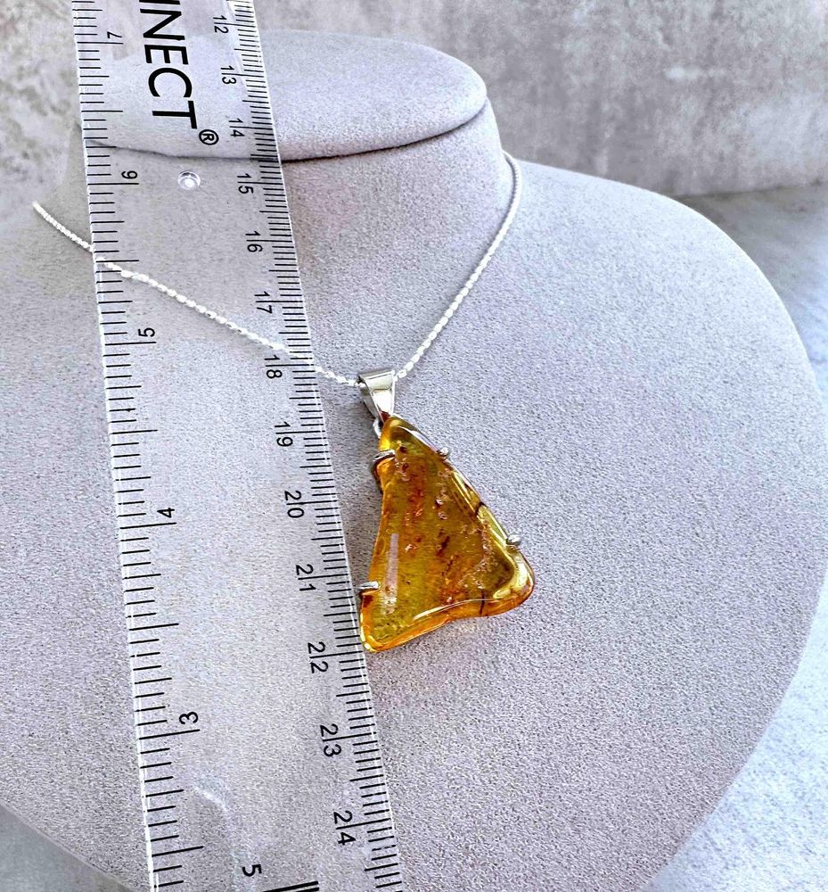 triangular genuine Amber sterling silver pendant on a chain with ruler to show size