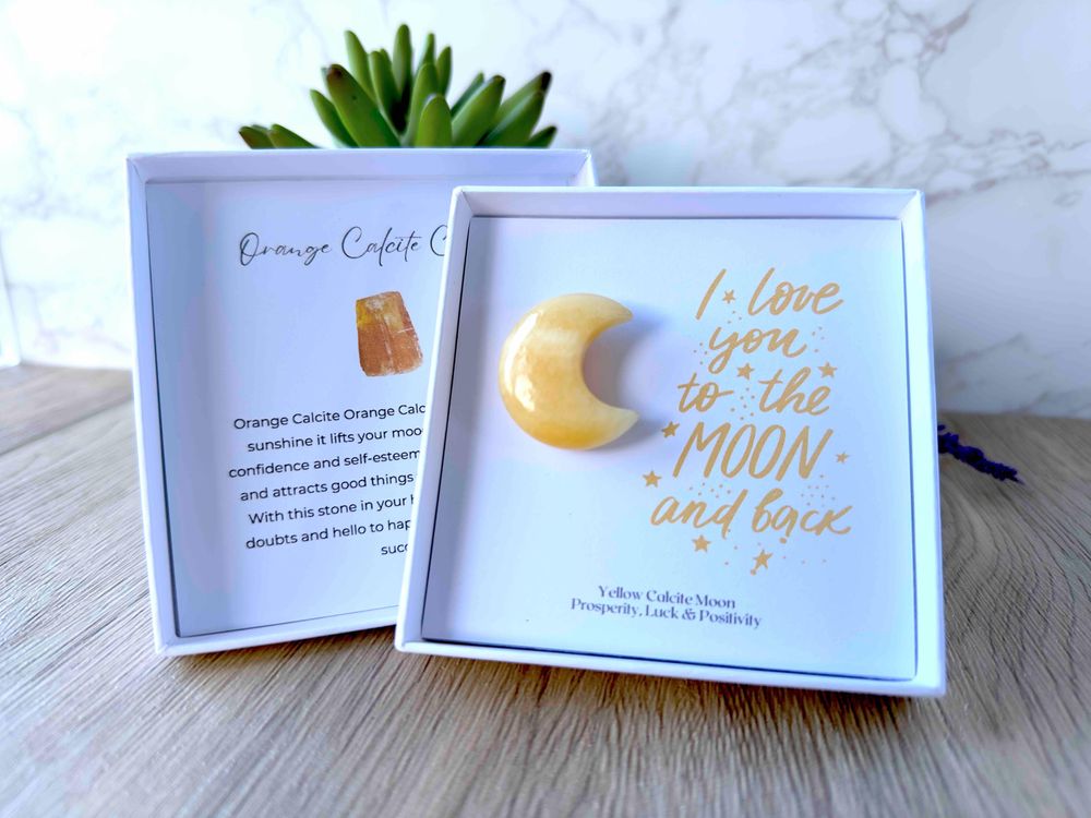 Orange calcite crystal moon in a gift box with the quote I love you to the moon and back within