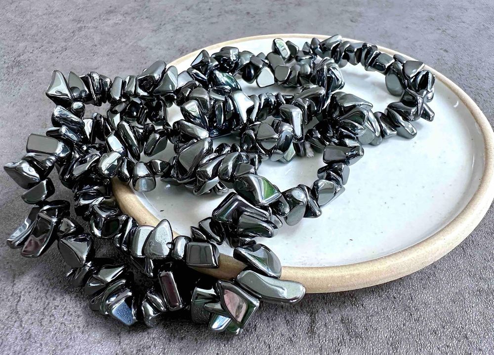 grey metallic hematite chip bracelets one size fits all on a dish