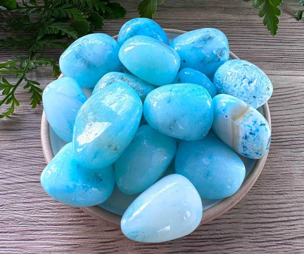Blue aragonite tumbled stones on a dish natural crystals