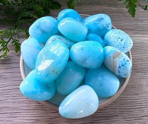 Blue aragonite tumbled stones on a dish natural crystals