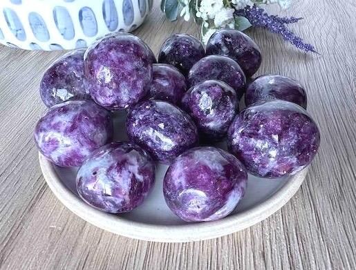lepidolite dark purple tumble stones on a dish from the holistic hamper UK crystal shop
