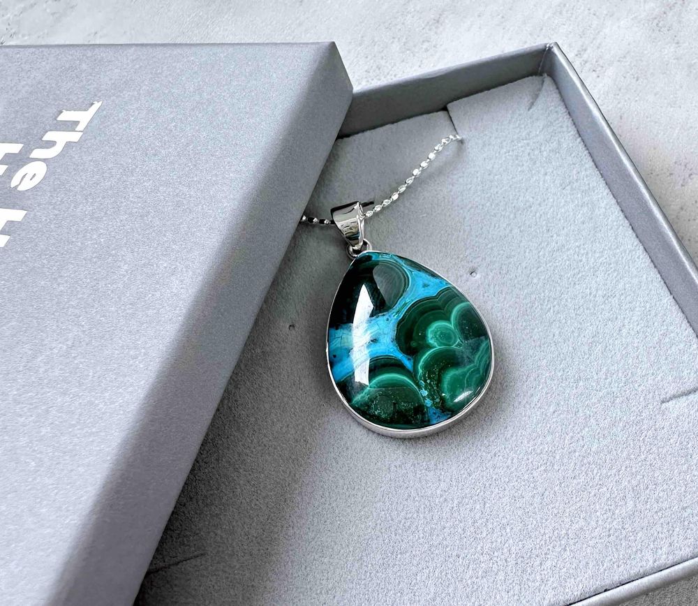 teardrop shape mallacolla sterling silver pendant on a chain in a presentation box