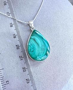genuine green malachite crystal pendant with sterling silver mount and optional chain showing ruler for sizing