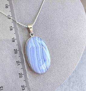 oval blue lace agate crystal pendant on chain with ruler to show sizing