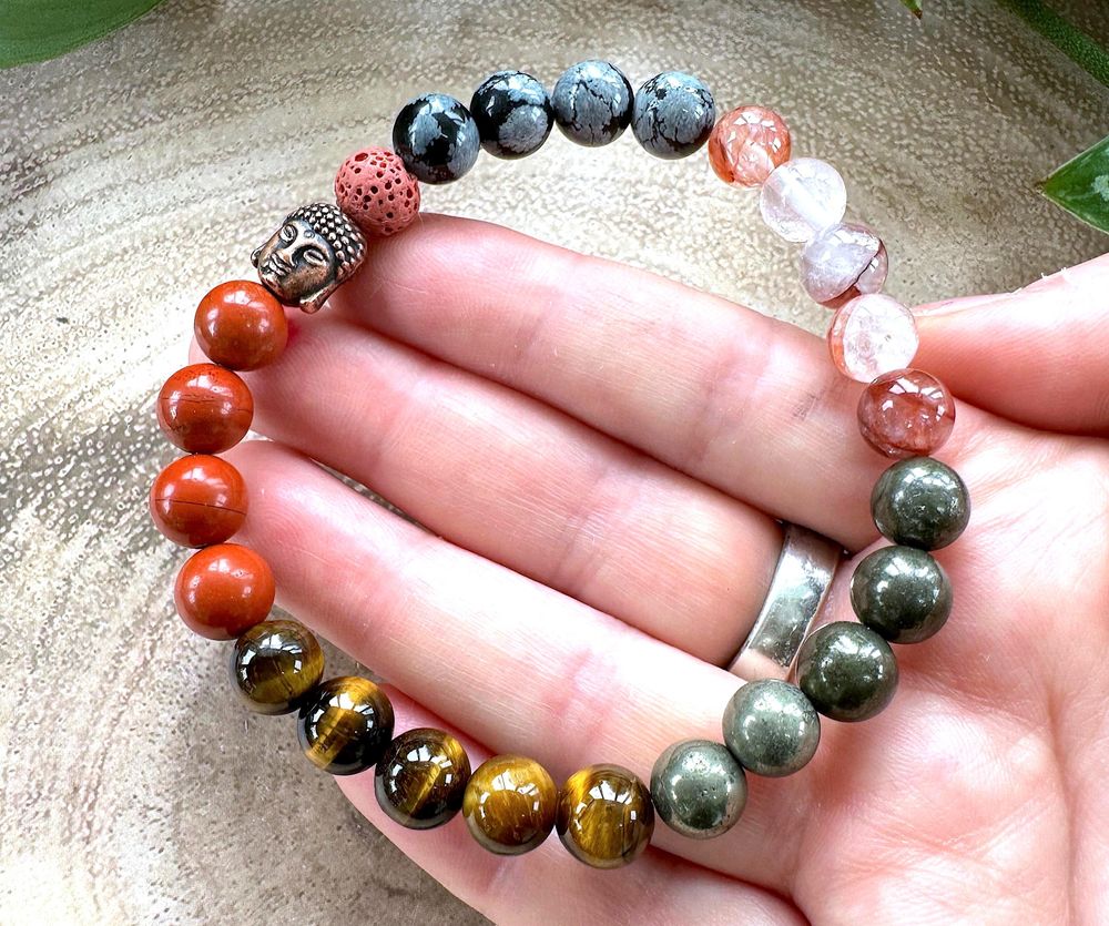 Red Mens Crystal Power Bracelet held in a hand