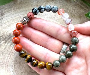 Red Mens Crystal Power Bracelet held in a hand