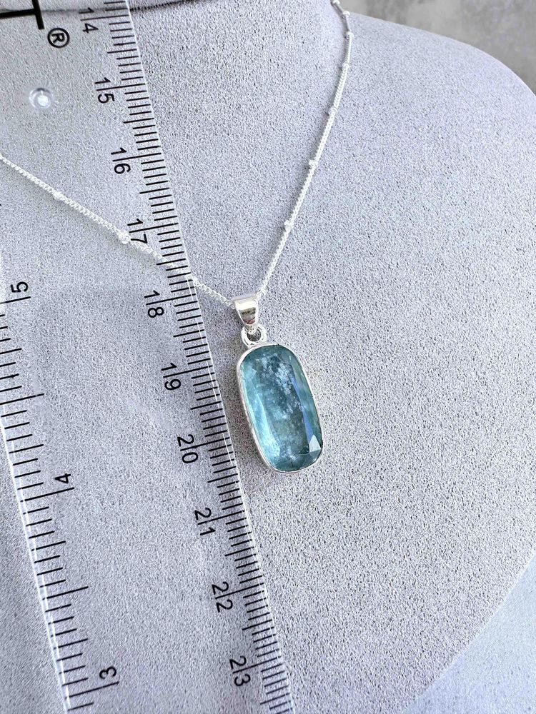 green kyanite rectangular crystal pendant on sterling silver on display bust with optional chain
