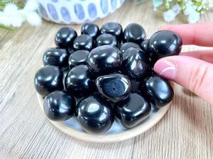 black obsidian tumble stones on a dish, the holistic hamper crystal shop