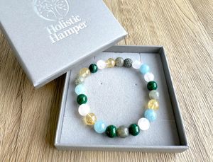 Scorpio zodiac crystal bracelet with lava diffuser bead in pinks, yellows and greens in a box