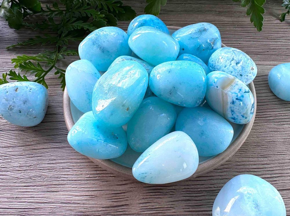 Blue aragonite tumbled stones on a dish natural crystals