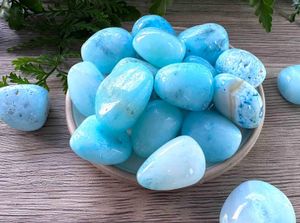 Blue aragonite tumbled stones on a dish natural crystals