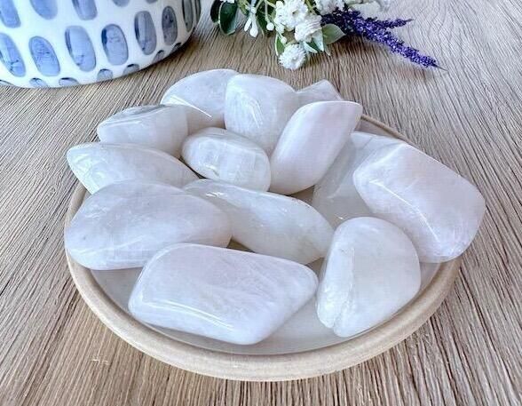high quality white rainbow moonstone tumbles on a dish