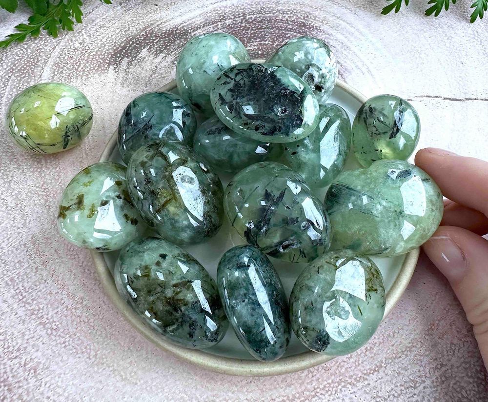 large prehnite green tumble stones with black tourmaline inclusions