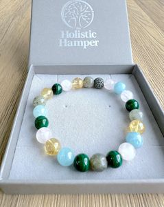 Scorpio zodiac crystal bracelet with lava diffuser bead in pinks, yellows and greens in a box