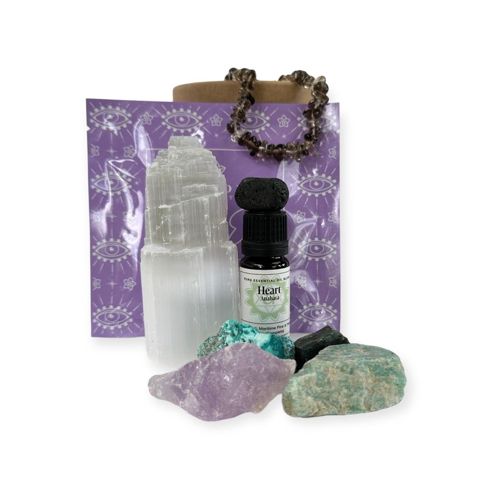holistic pamper pots for wellbeing with heart chakra essential oil blend, selenite tower, smokey quartz bracelet, four rough crystals and lava tumble
