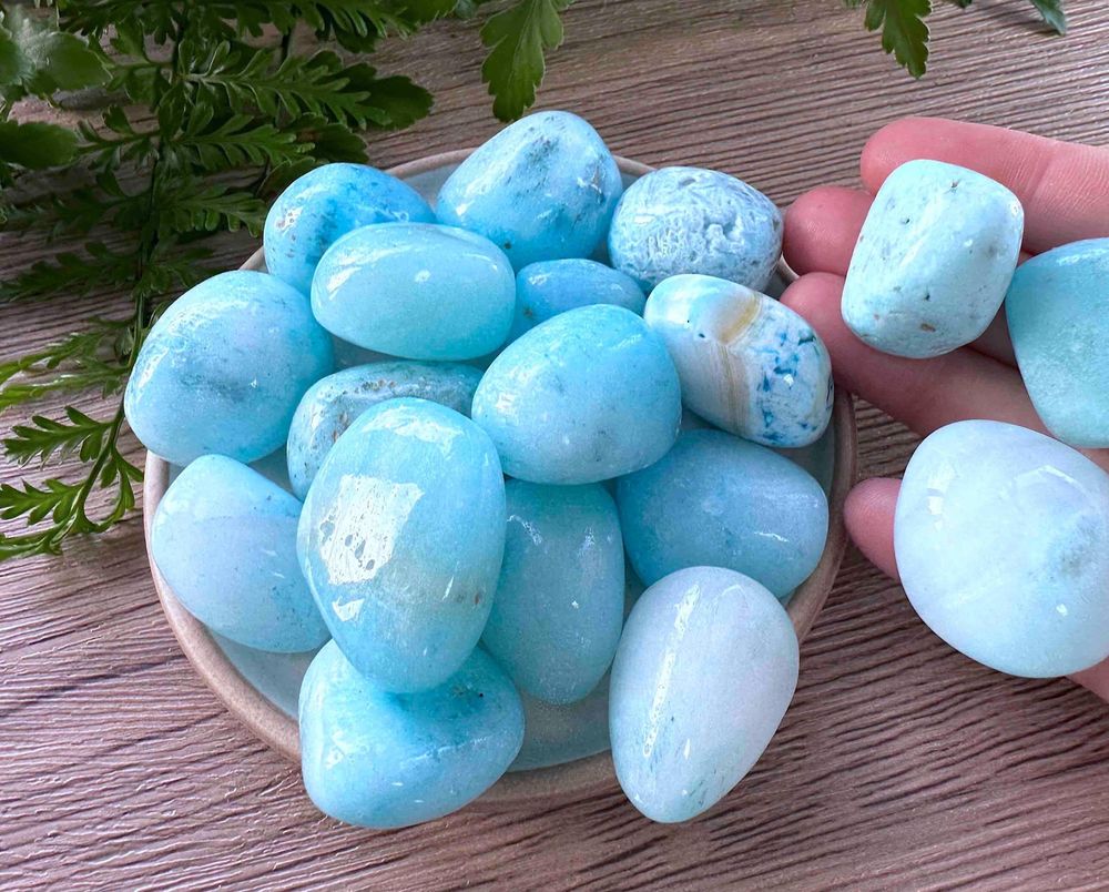 Blue aragonite tumbled stones on a dish natural crystals
