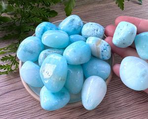Blue aragonite tumbled stones on a dish natural crystals