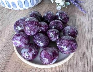 lepidolite dark purple tumble stones on a dish