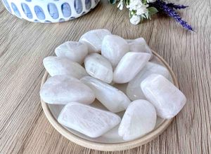 high quality white rainbow moonstone tumbles on a dish