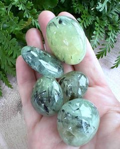 large prehnite green tumble stones with black tourmaline inclusions
