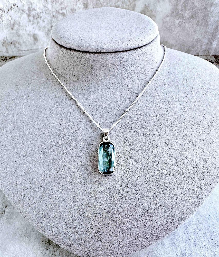 green kyanite rectangular crystal pendant on sterling silver on display bust with optional chain