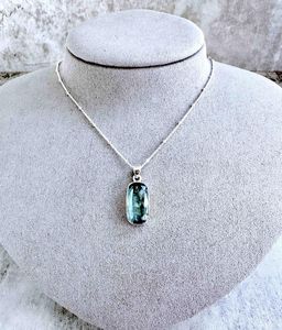 green kyanite rectangular crystal pendant on sterling silver on display bust with optional chain