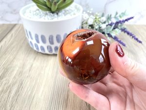 orange carnelian sphere with druzy and banding, the holistic hammer crystals UK