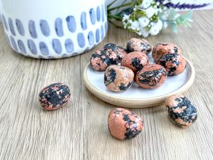 Luxullianite orange tumble stones with black tourmaline inclusions