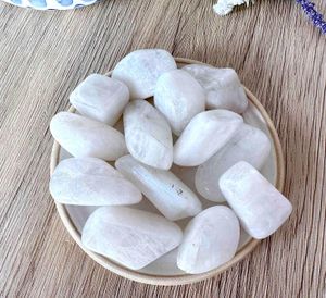 high quality white rainbow moonstone tumbles on a dish