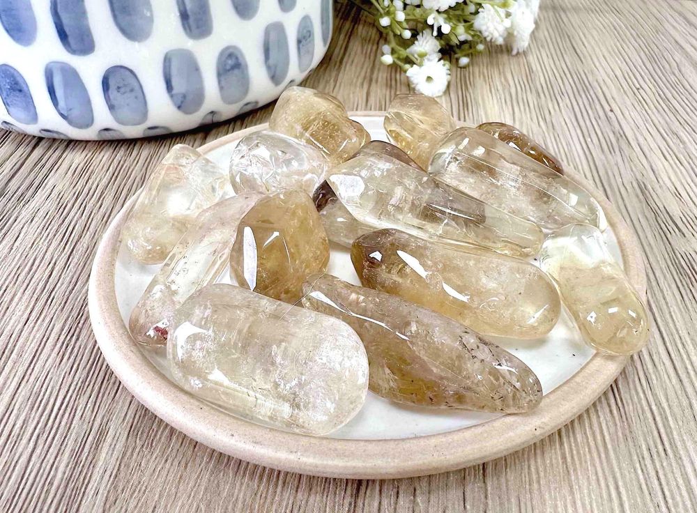 natural real citrine tumble stones on a dish
