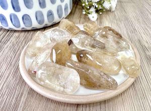 natural real citrine tumble stones on a dish
