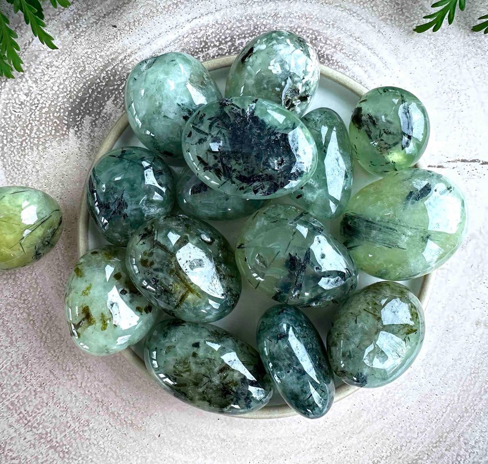 large prehnite green tumble stones with black tourmaline inclusions