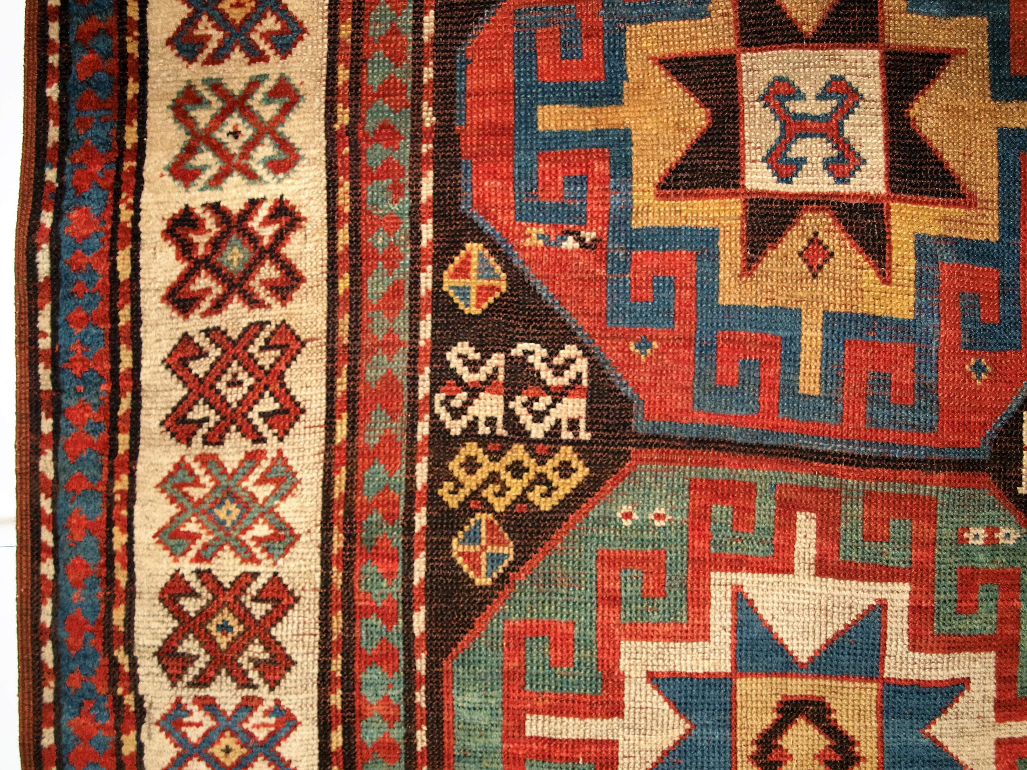 Geometric design detail of antique caucasian red/brown rug
