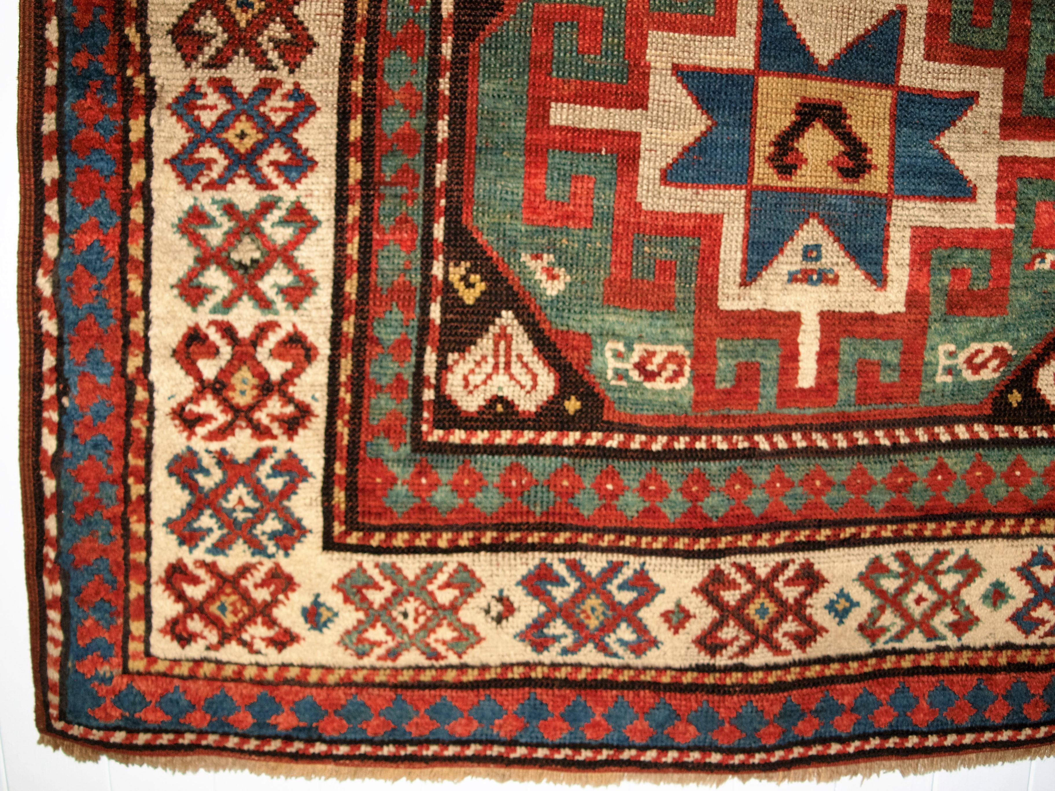 Geometric corner detail of antique caucasian red/brown rug