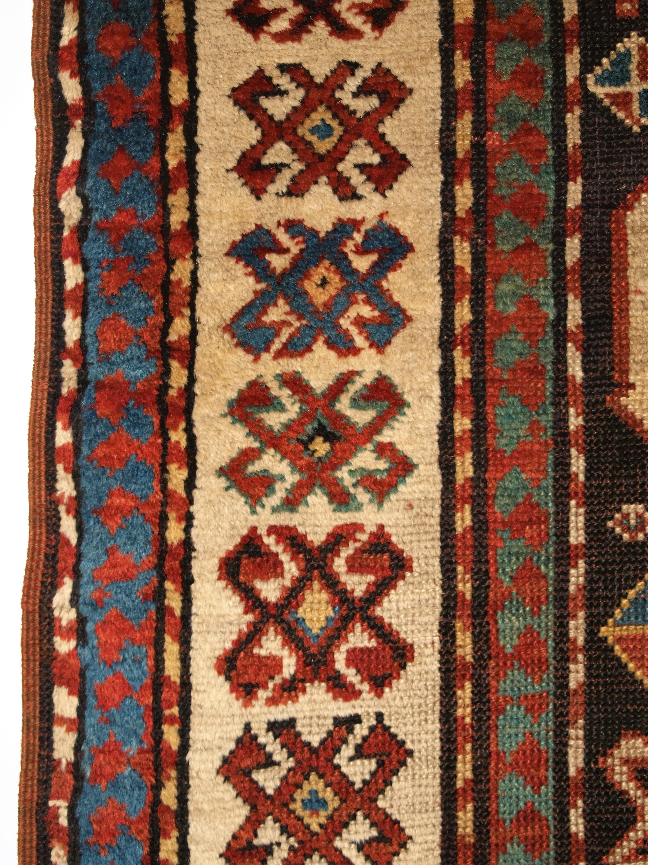 Geometric border detail of antique caucasian red/brown rug