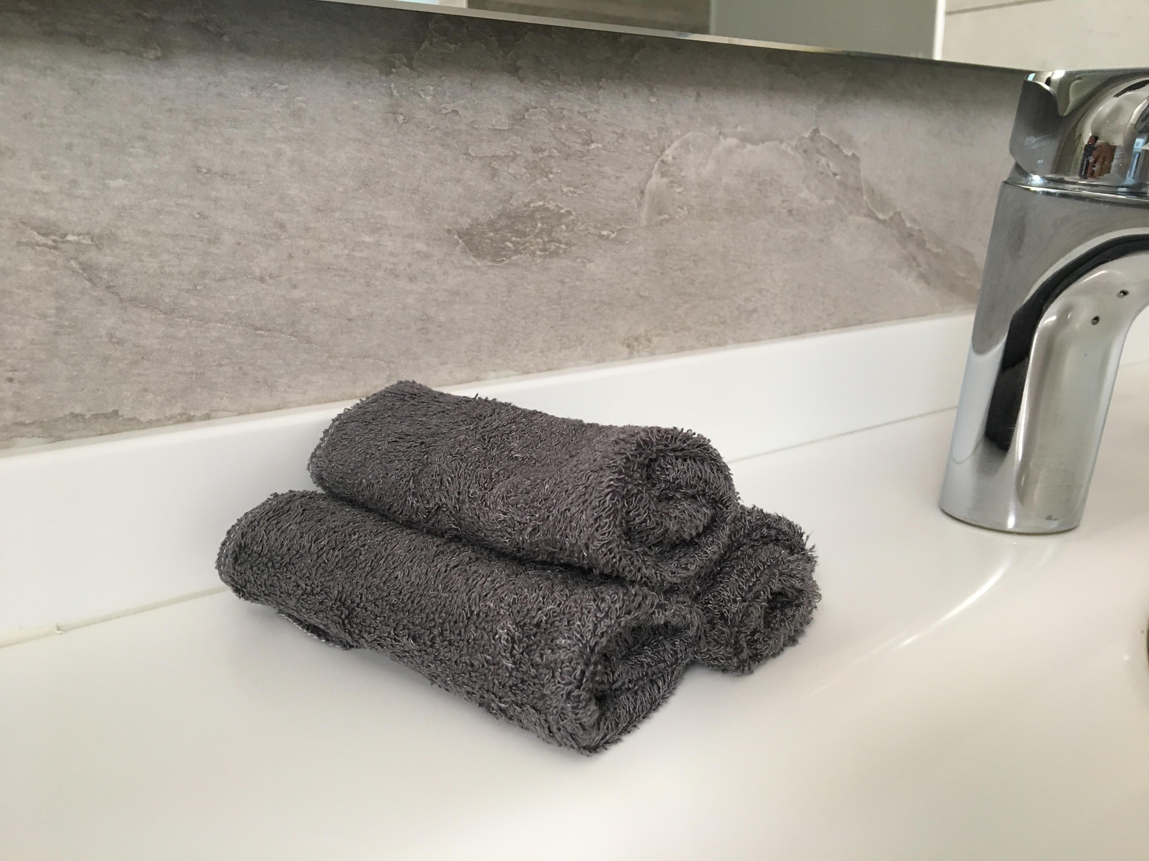 grey bamboo unpaper towels by the bathroom sink